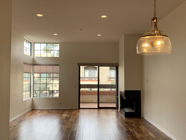 Dining, living room, balcony, fireplace facing north - 2601 S Broadmoor Dr
