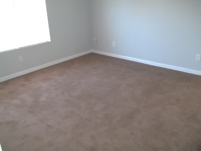 Building Photo - Freshly painted and new flooring in this 4 Bedroom 2 and Half Bath home. Covered front porch with...