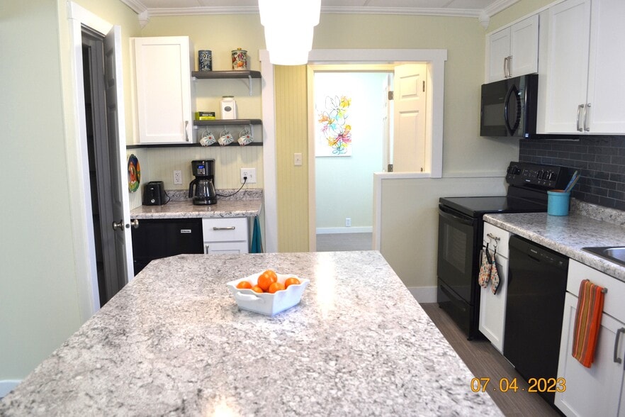 view thru kitchen toward back hall and laundry room - 222 W Peck St