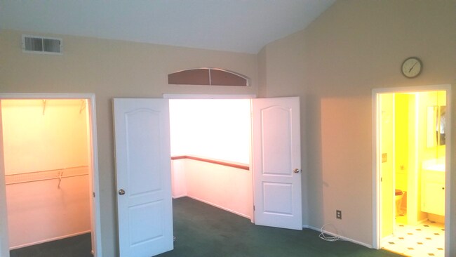 Primary Bedroom : showing walk-in closet, French Entry, and Primary Bathroom. - 18118 Flynn Dr