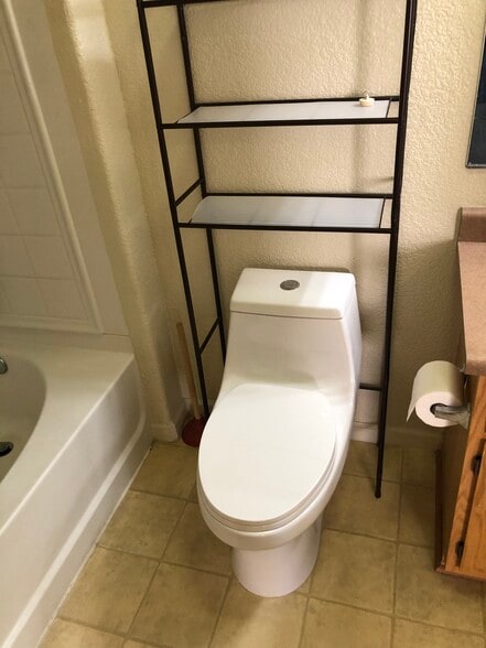 Master bath has newer elongated soft close duel flush toilet - 10001 Woodcreek Oaks Blvd