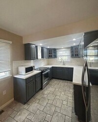 Building Photo - Close to Campus! 4BR Home with Finished Basement, Private Parking & Hardwood Floors