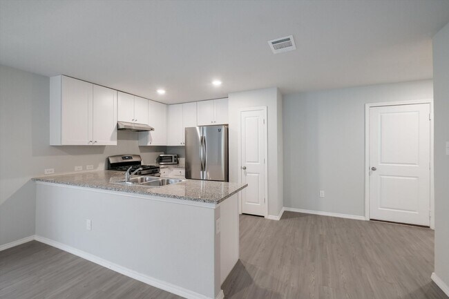 Building Photo - Open-Concept Living with New Flooring