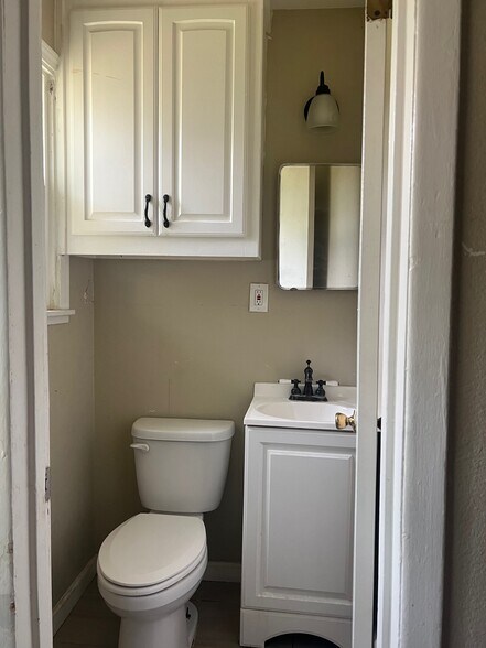 Renovated half bath off the primary bedroom. - 4244 Asbury Ave