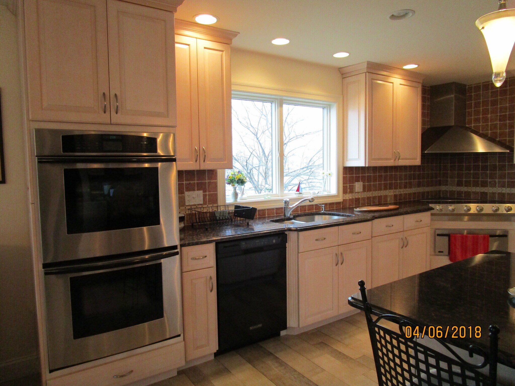 kitchen main preparation area with double oven, dishwasher, sink, electric cooktop, warming oven - 103 Summer St