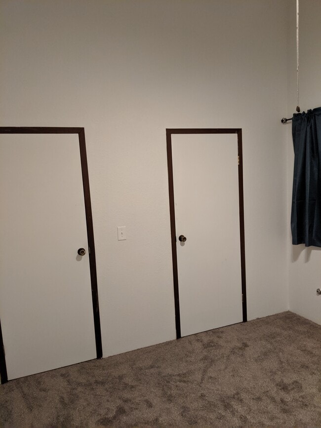 Bedroom 2 looking at the door to the landing and the door to the walk in closet. - 2115 Pleasanton St