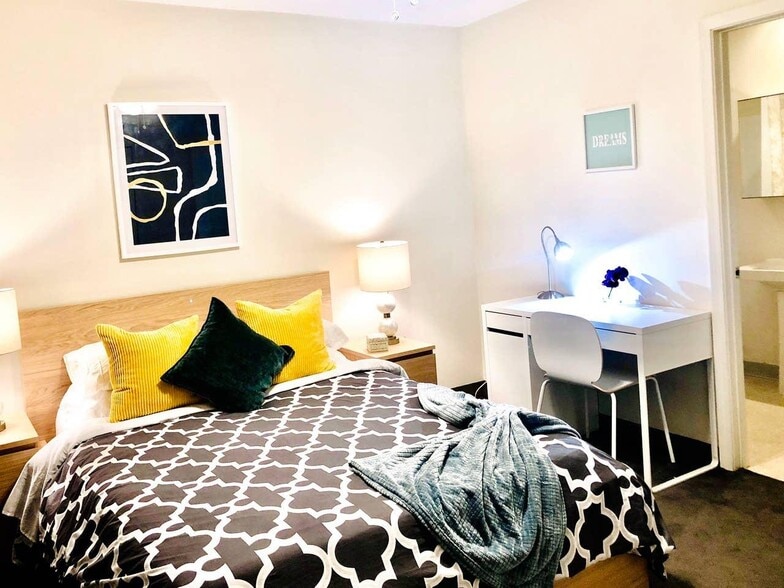 First bedroom has a queen-size mattress and a private bathroom inside. A spacious closet (not in photo) is also a plus - 621 W 43rd St