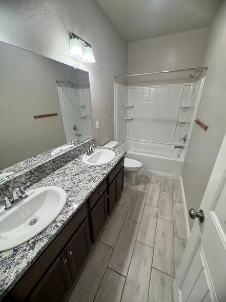 Hall bathroom with a tub/shower combo - 11281 E Belmont Ave
