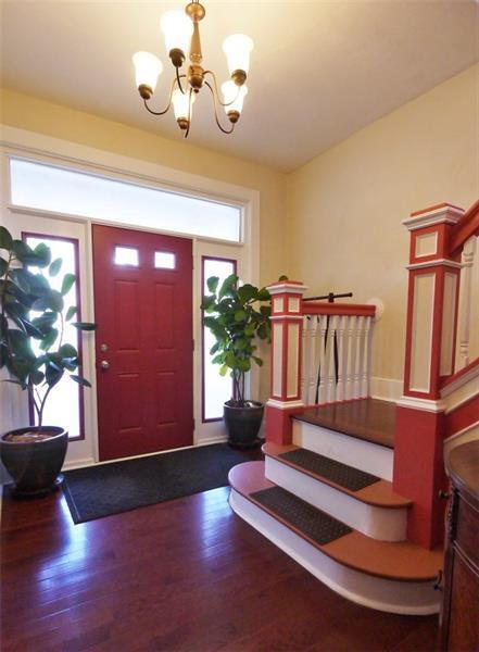 The house has a great entry way and staircase to welcome you home. - 1109 Haslage Ave