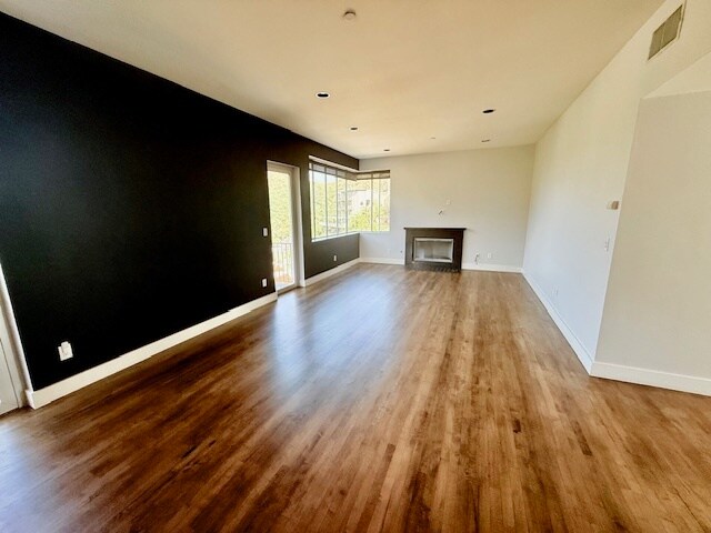 Living/dining area with sweeping city, canyon and ocean views and contemporary gas fireplace - 6396 Weidlake Dr