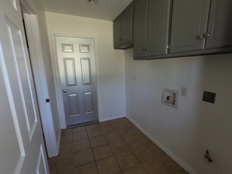 Utility/laundry room with door to garage - 415 W Guthrie St