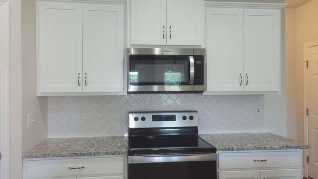 Building Photo - "Spacious 4-Bedroom Retreat with Modern Gr...