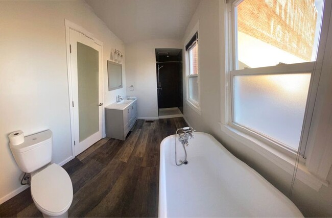 bathroom off of bedroom with tub and shower - 106 S 3rd St