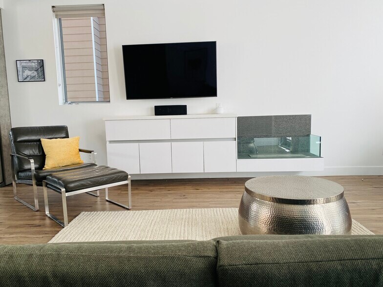 2nd Floor living room with 5.1 Surround sound and full-motion 55'' smart TV so you can watch from an - 7197 Formosa Fusion Ct
