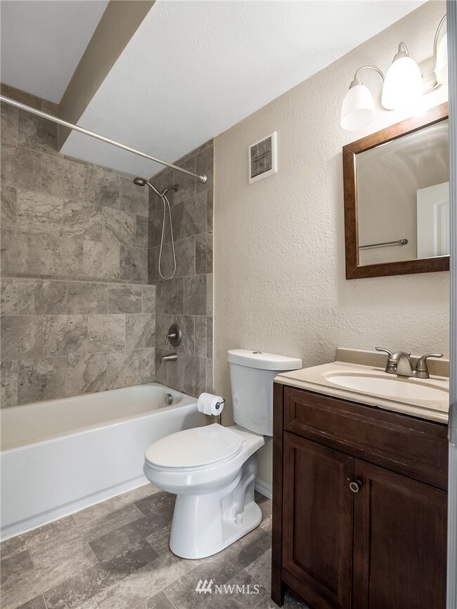 Full sized and tiled bath with a shower - 10306 41st Trl SE