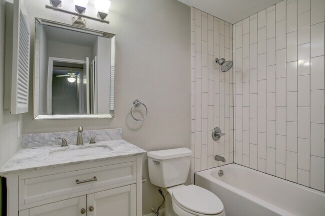 Contemporary full bath #1 with updated features and tons of storage. - 1880 White Oak Dr. Apt 119
