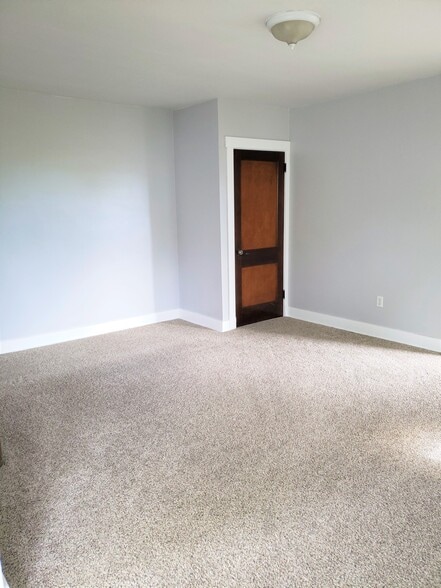 An additional photo of the living room shows the large living space and closet for storage - 201 Richbarn Rd
