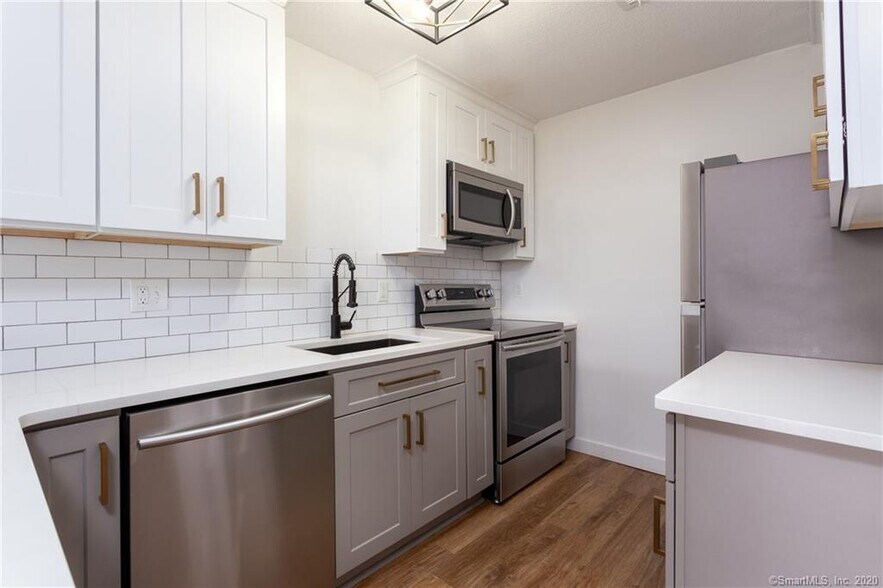 White quartz counters and grey shaker cabinets - 188 Flax Hill Rd