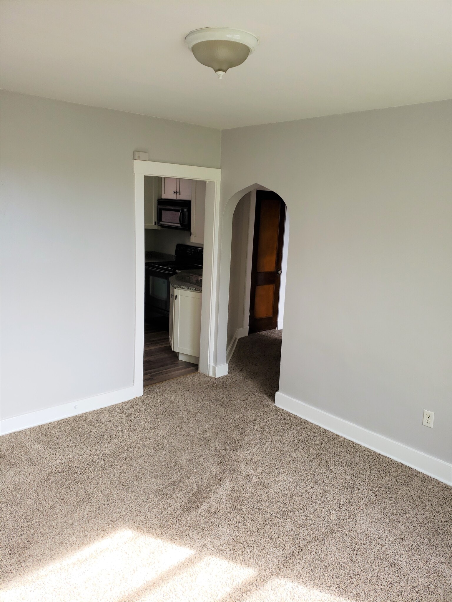 The dining room leads to the kitchen on the left and the hallway on the right - 201 Richbarn Rd