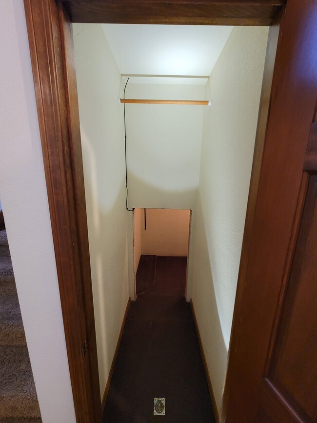 Downstairs Coat closet with storage room behind - 8000 Little Dipper Ave