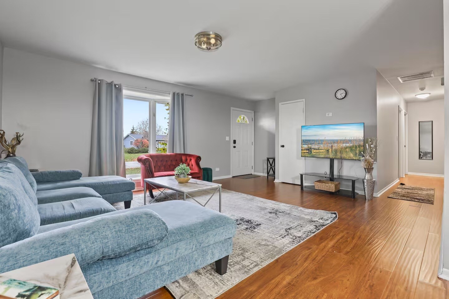 Living room with sleeper couch, smart TV and closet space. - 1002 Juniper Ln