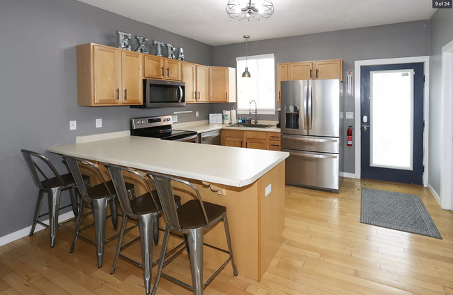 Kitchen provides healthy room to cook, chat as well as access the outdoor private yard - 584 N 8th W