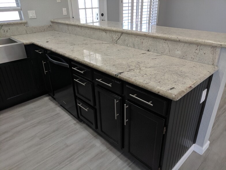 Granite counter tops and brushed nickel hardware with stained wood cabinets. Upgraded Whirlpool Dishwasher. - 14101 N 78th Dr