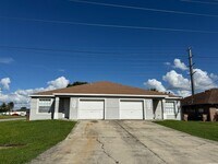 Building Photo - Experience this Cape Coral 3 bedroom 2 bath corner duplex with 1 car garage and screened in lanai.