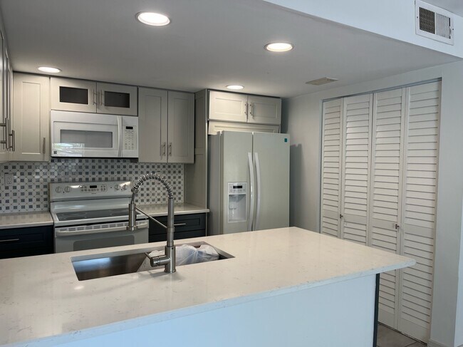 New cabinets, washer and dryer behind bifold doors - 4580 SW 68th Court Cir