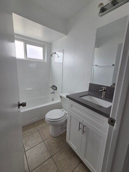 Bathroom with new cabinets and quartz countertops - 3455 Elm Ave