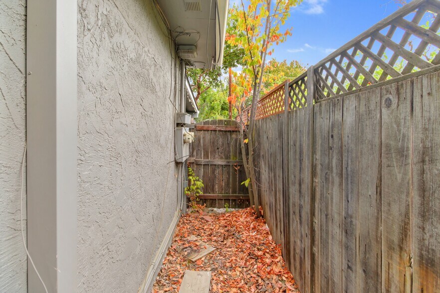 Side yard storage area for bikes, BBQ, outdoor chairs, etc. - 47 Fallon Ln