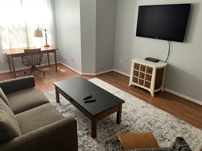 cozy living room with HDTV and desk - 735 Walker Square