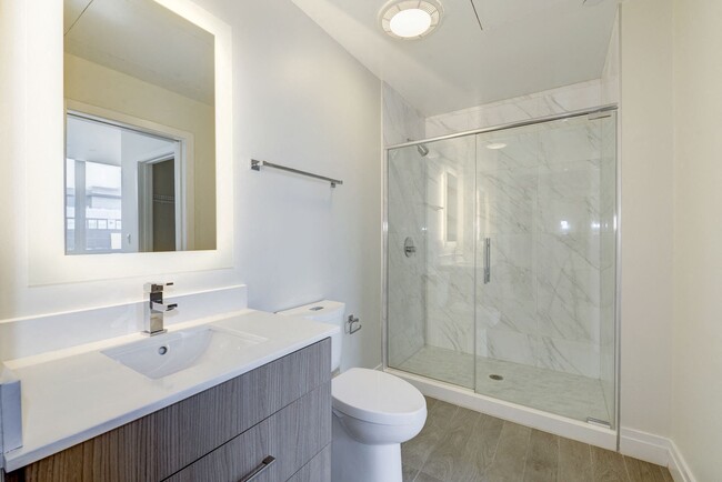 Spacious Bathrooms with LED Back-lit Mirrors - Elysium Fourteen