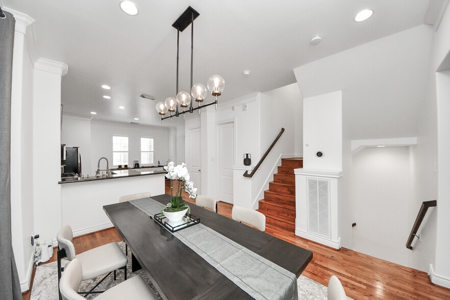 Soft natural light filters through layered draperies, creating a serene dining atmosphere. - 620 Rutland St