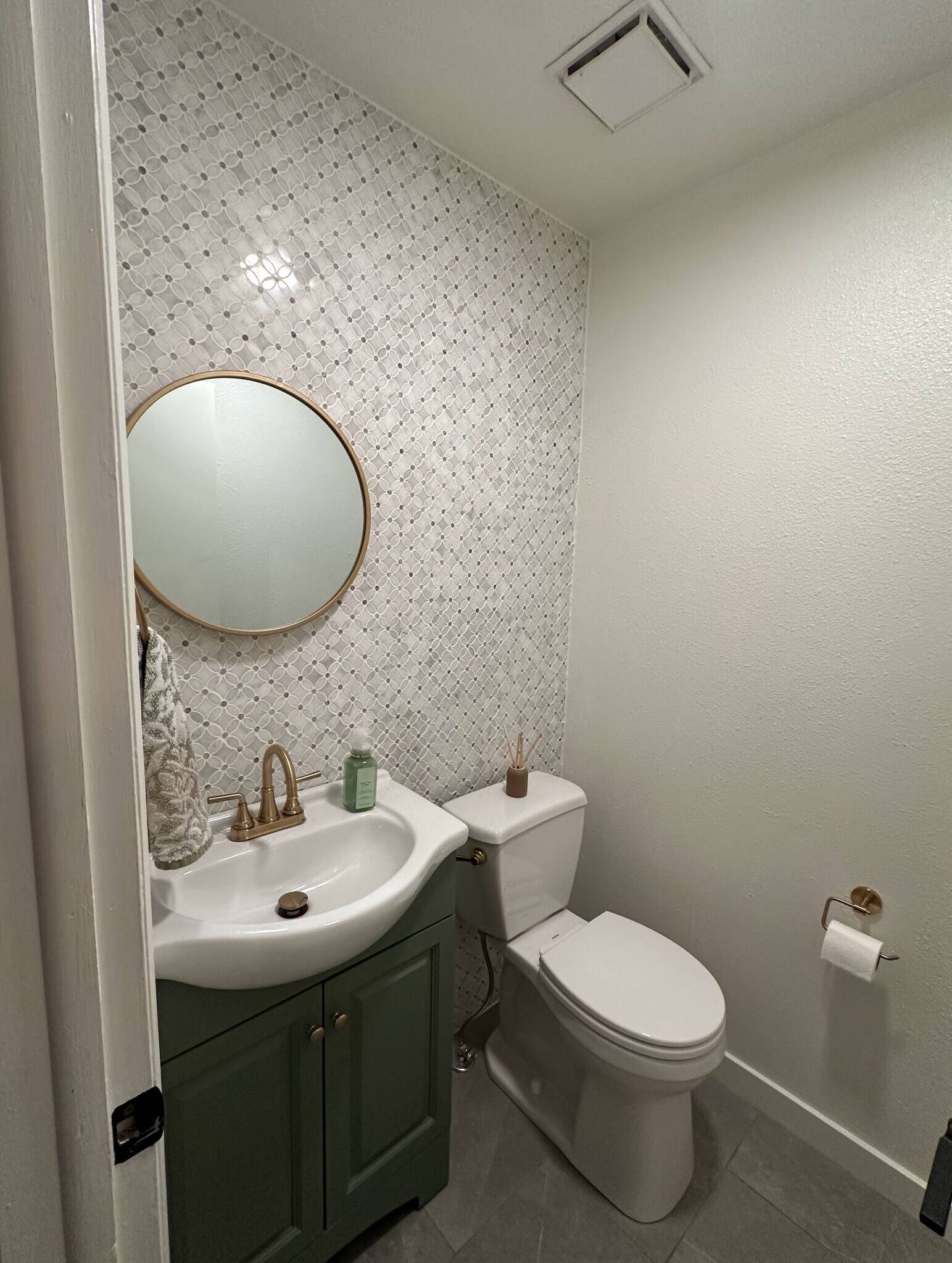 Custom powder room accented by a striking marble tile feature wall. - 524 Superior St