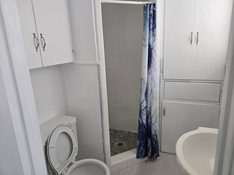 Master bath corner shower and custom built cabinets with laundry basket - 2863 Colorado Ave