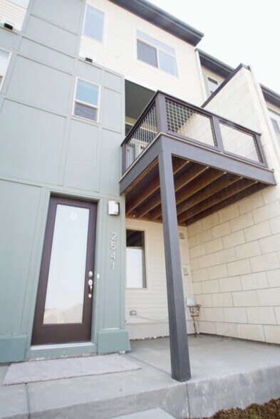 Entry with patio and deck above. - 2541 Moline St