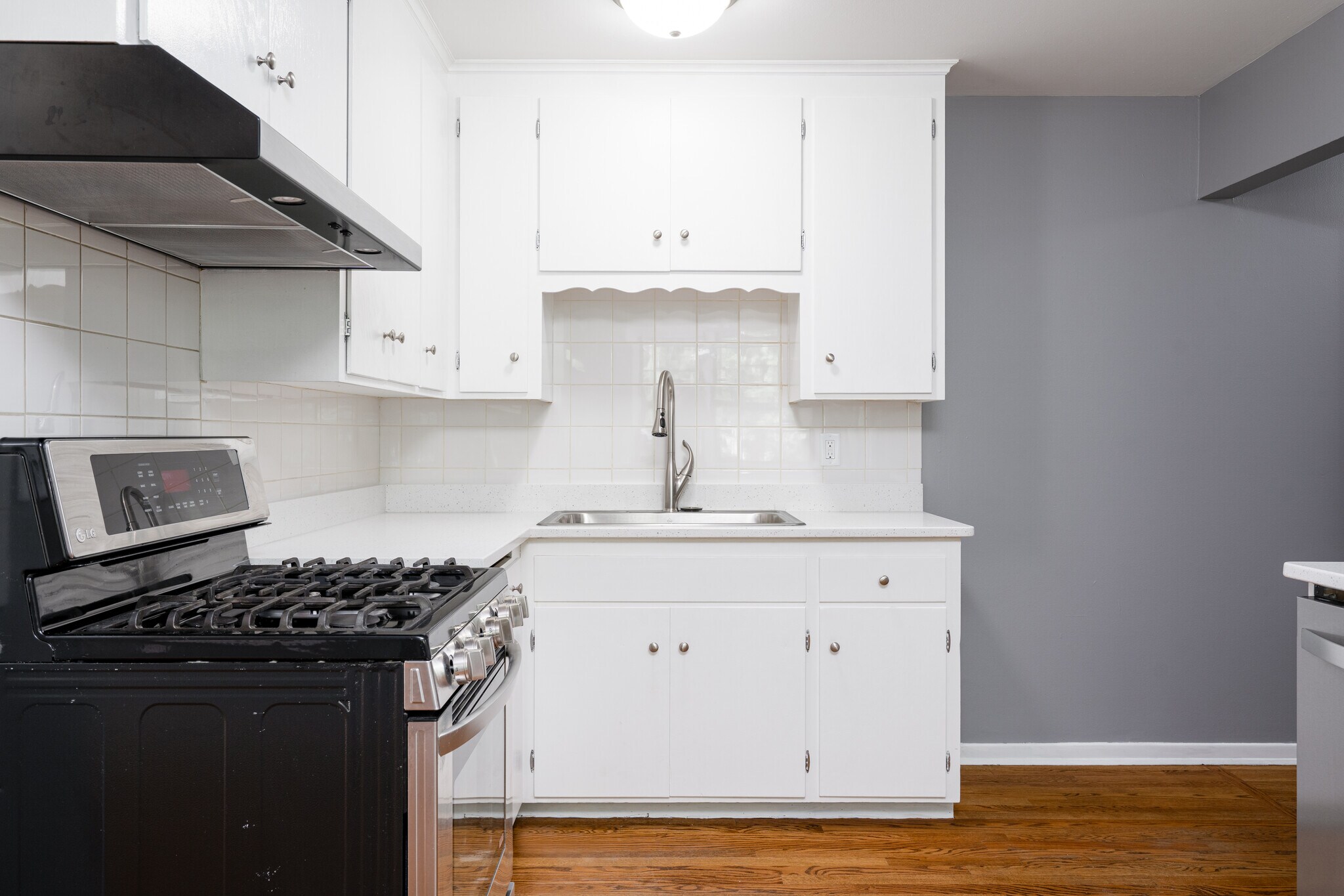Kitchen with New Range Oven, Sink, and Quartz Countertops - 5312 Hiawatha Ln