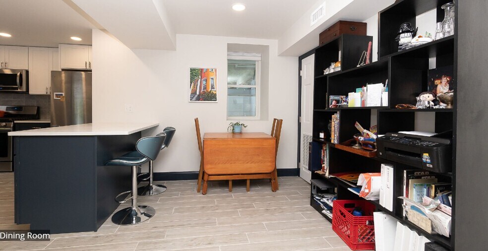 Open Concept dining area next to island with counter seating - 8 Alveston St