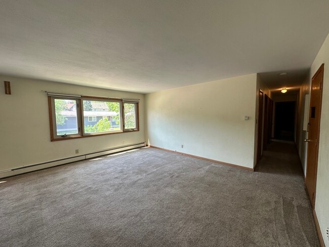 Large living room open to dining room. - The Virginian Apartments