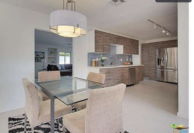 Dining table off open, bright kitchen. - 2080 E McManus Dr