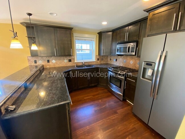 Building Photo - Spacious townhome with private backyard, garage parking, multiple decks, and a dedicated home off...