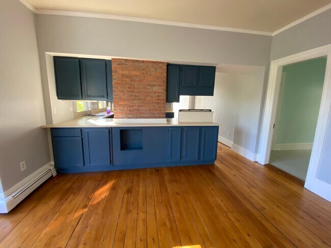 Exposed brick in dining room adjacent to kitchen - 86 Holden St