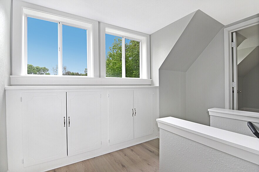 Bright upper landing with natural light from the windows and built in storage. - 32584 River Vista Ln