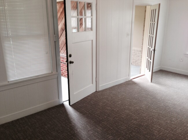 Living room view of front door and sun porch/office to the right. - 4104 Dover St