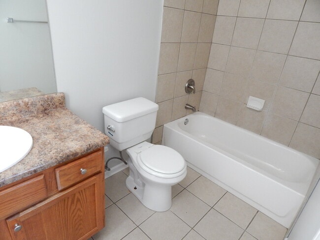 Building Photo - Freshly painted and new flooring in this 4 Bedroom 2 and Half Bath home. Covered front porch with...