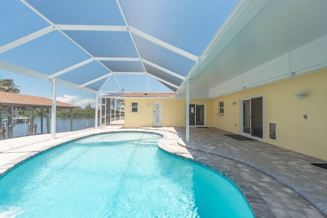 Building Photo - Live the ultimate Space Coast waterfront lifestyle at this stunning beachside canal home in Satel...