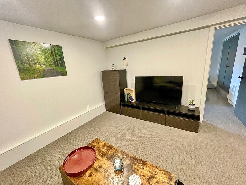Entertainment center with TV - 5306 NE 15th Ave
