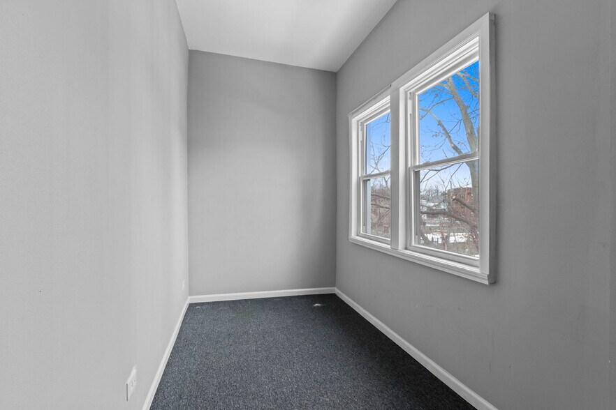 Private enclosed back porch providing additional living space and flexibility beyond the main rooms. - 7028 S Peoria St