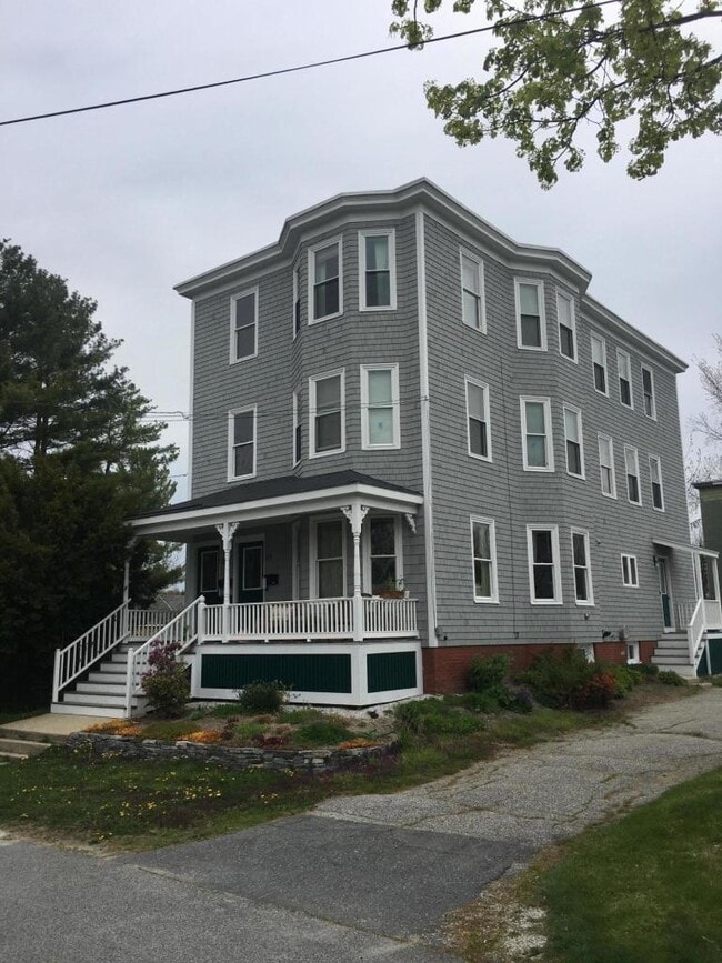 Outside with covered porch, off street parking, and cedar shake siding - 23 Savoy St